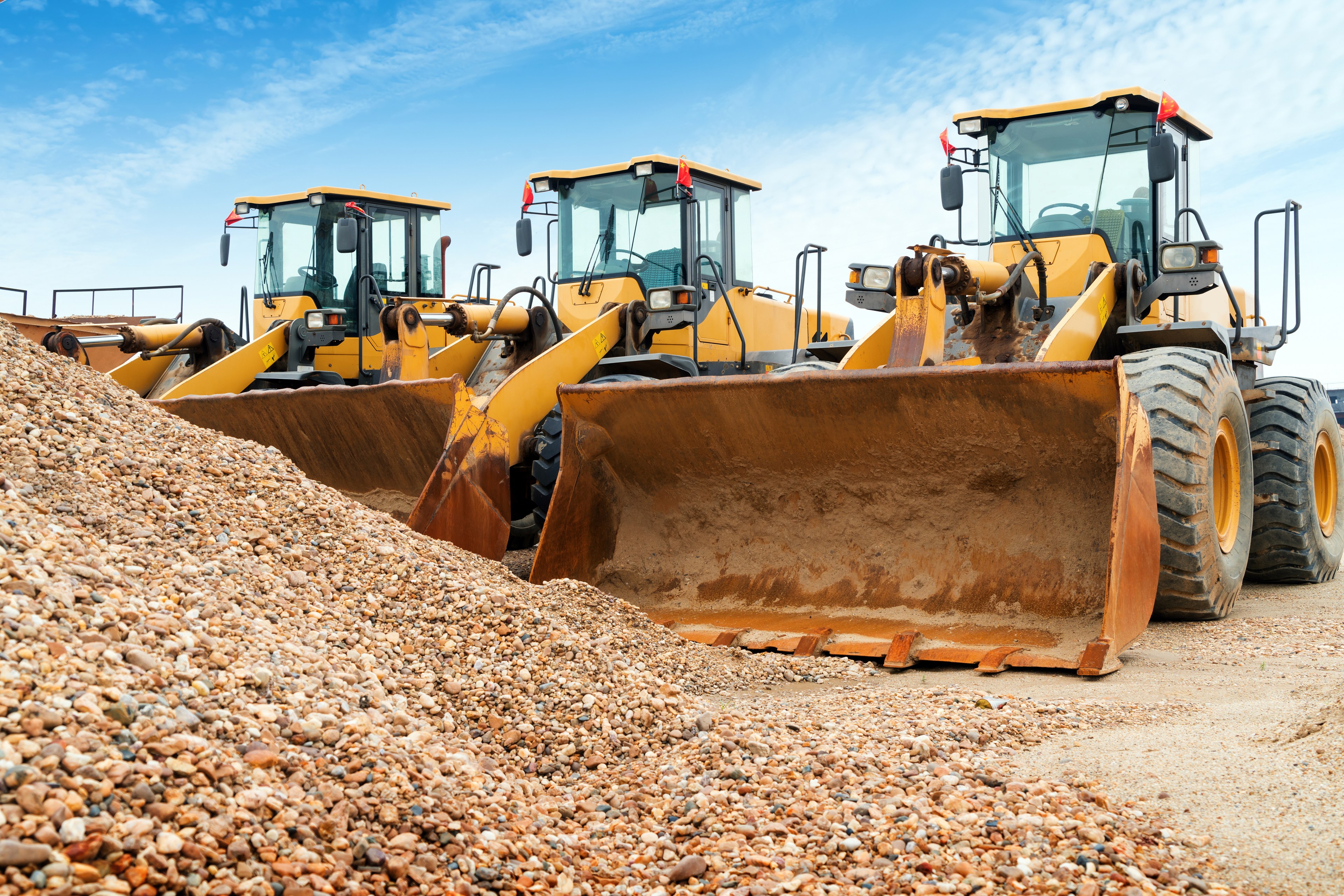 Yellow front-end loaders on a construction site