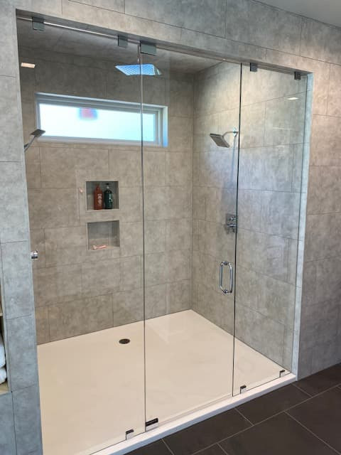 Custom glass shower enclosure with clear frameless panels