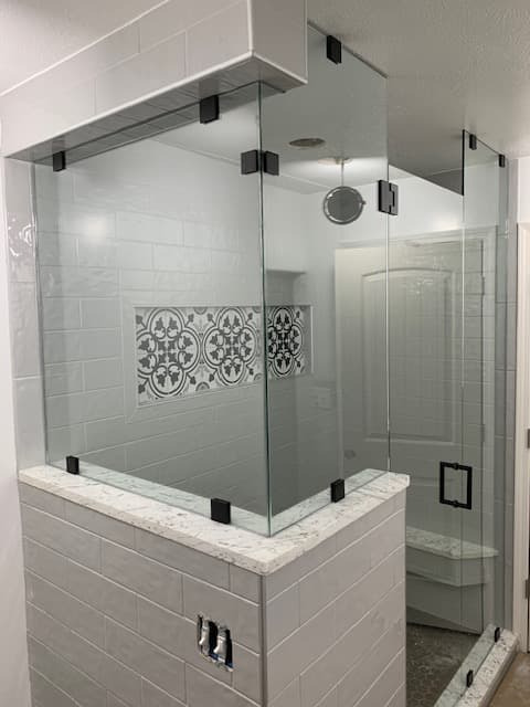 Large sliding glass shower with wood-look tile and accessibility grab bars