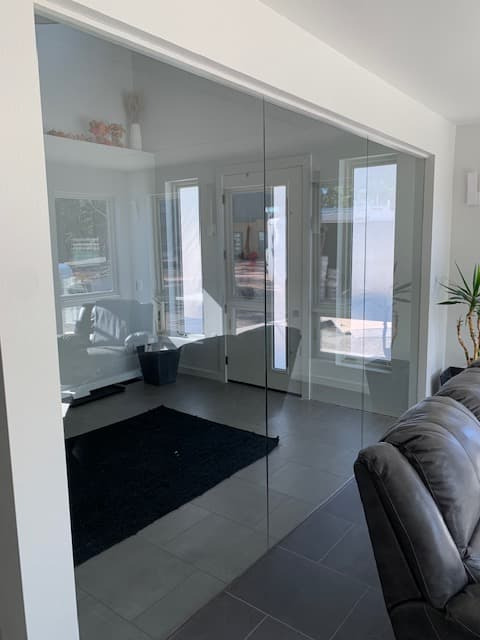 Accessible shower with sliding glass doors and safety grab bars